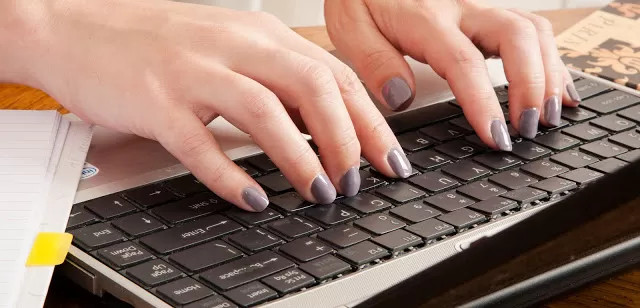 Fingers typing at a keyboard