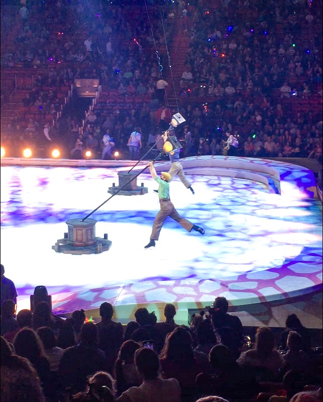 Acrobats spinning on light polls at Disney On Ice presents Road Trip Adventures